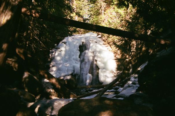 waterfall in rocky ravine frozen in ice