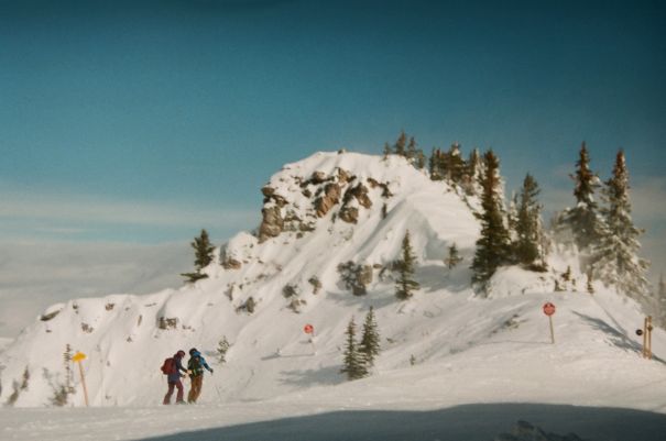 windblasted mountaintop with skiers hunkered down